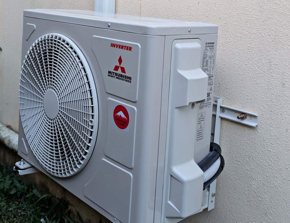 Mitsubishi Heavy Industries inverter outdoor unit on wall brackets with covered pipework